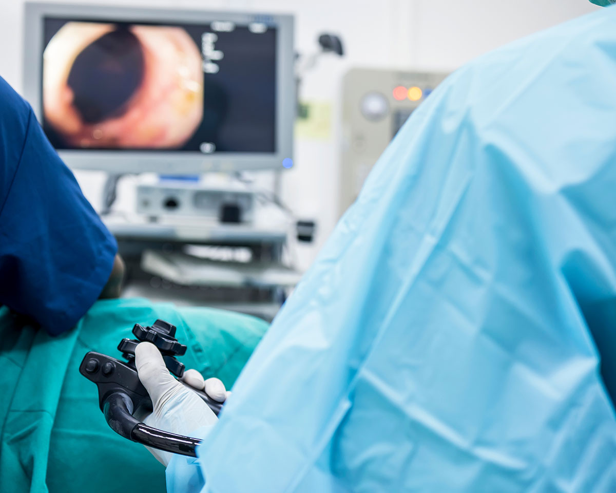 Doctor performing a gastroscopy procedure in Singapore with real-time endoscopic visuals on screen during digestive tract examination.