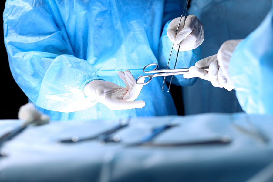 Surgeons preparing instruments in the operating room for colorectal surgery cost in singapore procedure.